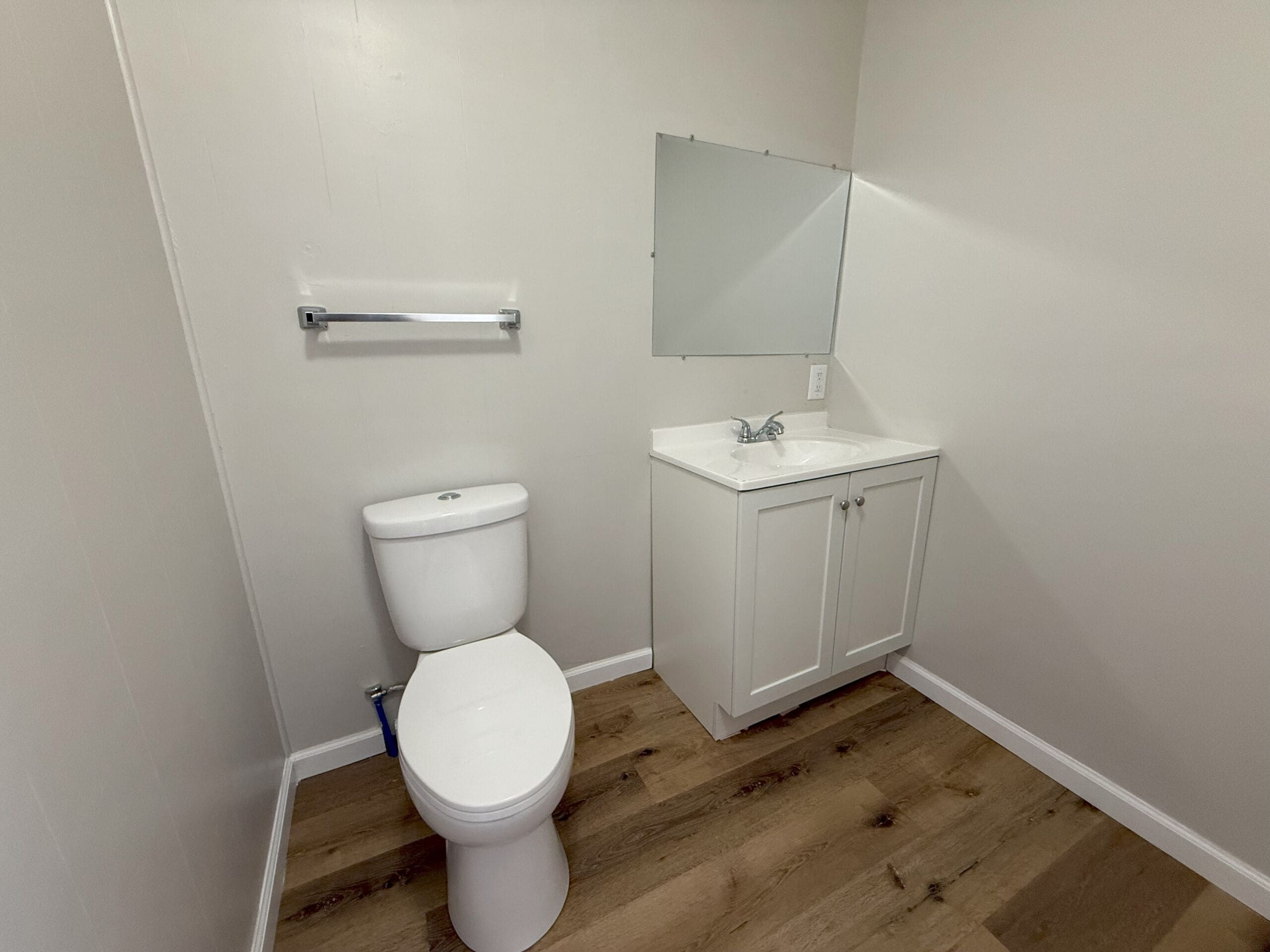 Updated half bathroom with white vanity and modern fixtures